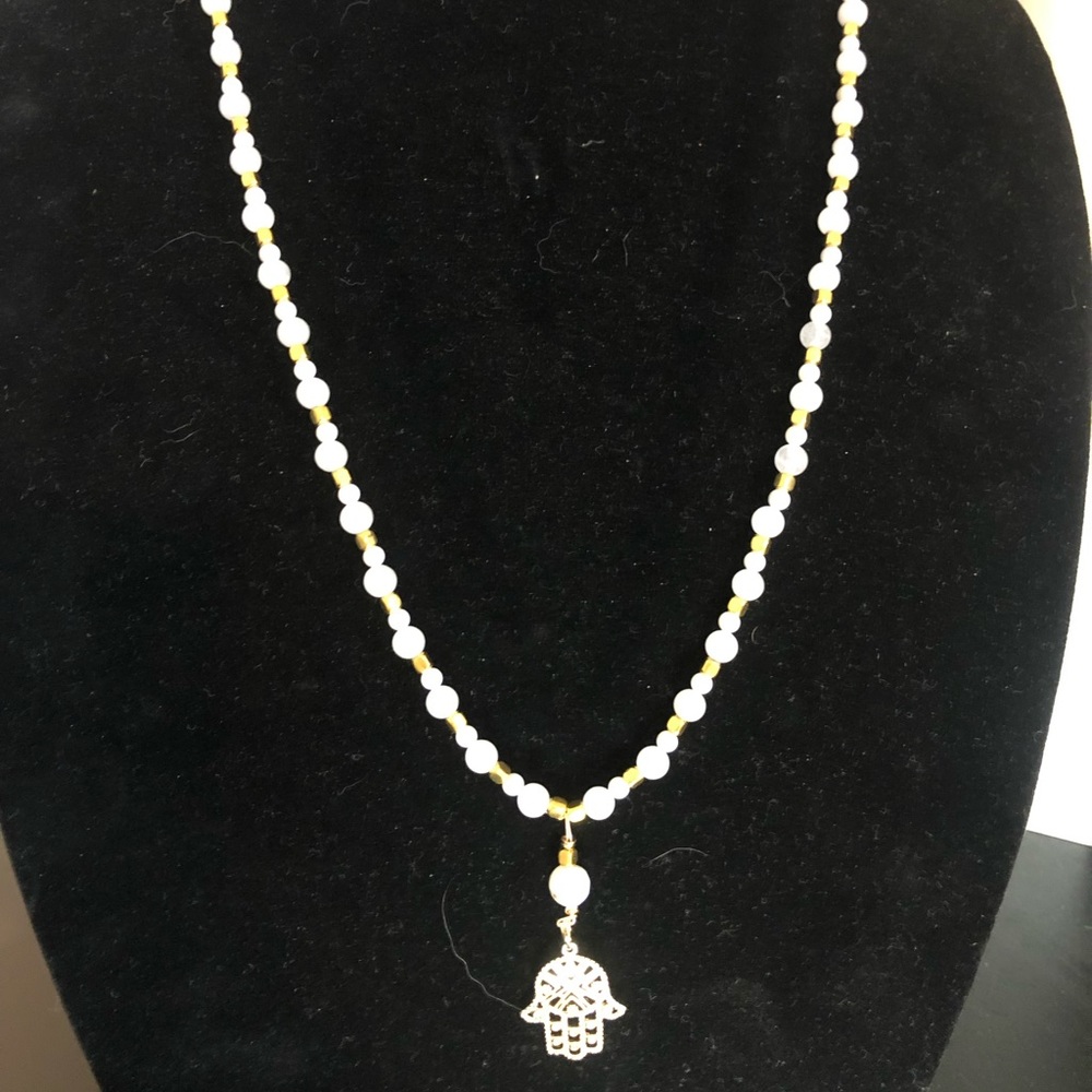 Gold tone Hamsa pendant necklace.